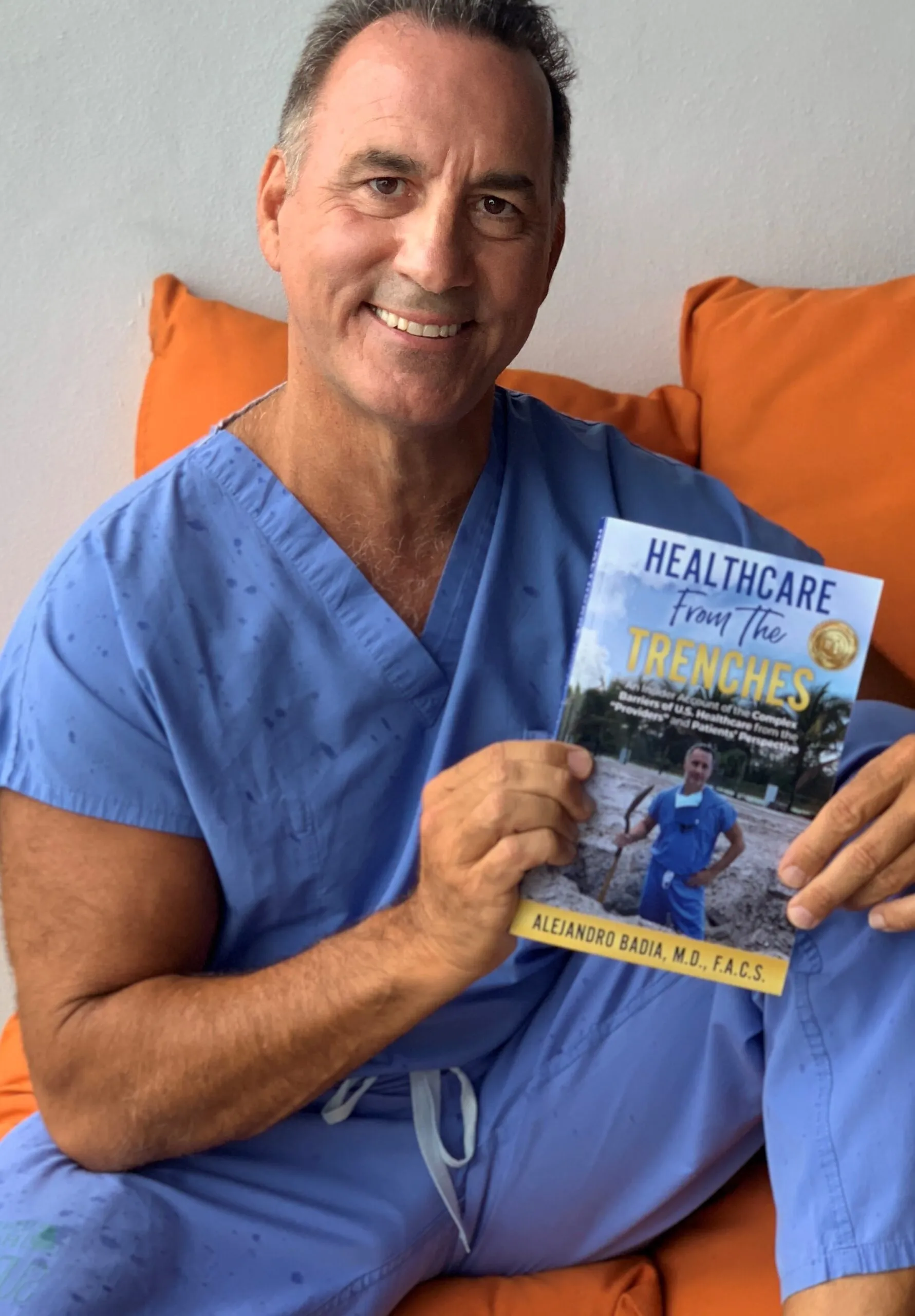 Dr. Badia holding his book Healthcare from the Trenches